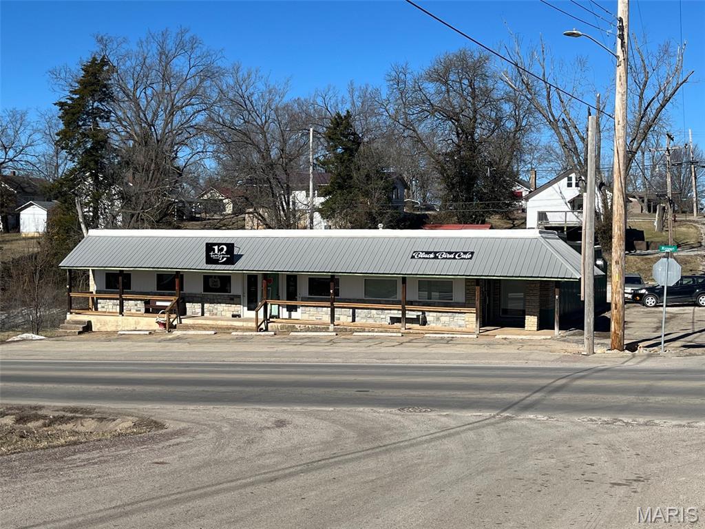 MOTIVATED SELLERS! Here is a great investment property!  The building has had a bunch of updates done; new roof (with 20 year warranty), windows, doors, siding, stonework... The long term renter has taken such good care and has a perfect set up for what they do. The restaurant side has 1.5 bathrooms. There are two more rentals (currently empty) with each having their own half bathrooms for rent. Possiblities are endless!  The tenants pay their own utilities. Looking for a great way to make an investment for your future.... Here you go!! Location: City, Corner, High Traffic!