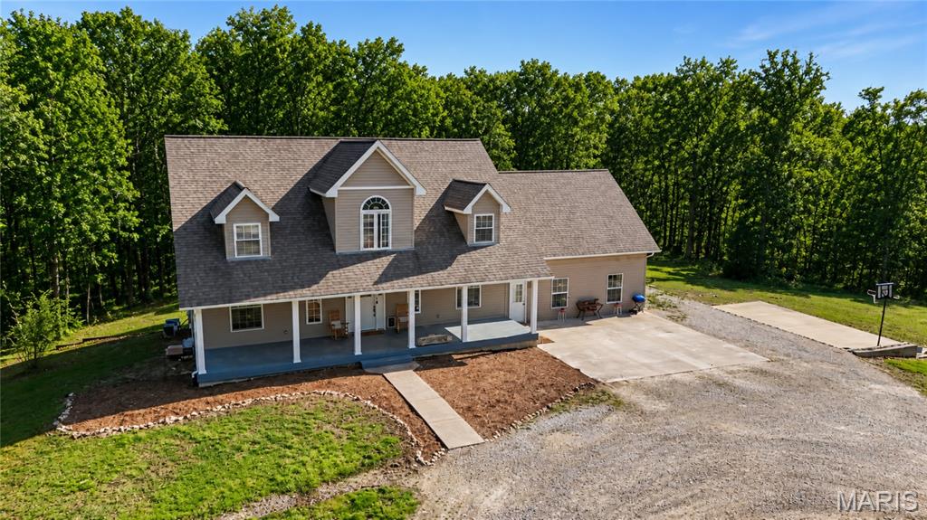 Tucked away on nearly 14 wooded acres, this private retreat offers the space, flexibility, and lifestyle buyers are actively searching for. This 6-bedroom, 3.5-bath home combines an open floor plan with true seclusion, making it ideal for multi-generational living, large households, or anyone craving privacy without sacrificing convenience.

Step into the stunning great room featuring vaulted wood ceilings and a two-story wood-burning fireplace, the perfect centerpiece for gathering and everyday living. The open kitchen includes a center island, bay window, and abundant cabinetry, flowing seamlessly into the main living areas.

The main-floor primary suite provides convenience and comfort, while the private in-law quarters offers incredible versatility for extended family, guests, or a home office setup.

Outside, the property truly shines. Enjoy 13.99 acres of wooded land complete with trails, a natural creek, and abundant wildlife. Whether you're sipping coffee on the oversized deck, hosting summer gatherings by the pool, or enjoying the basketball court, this property delivers a lifestyle that’s hard to find.

Recent updates include a new roof, new well pump, updated lighting, new carpet, and improvements to the primary bath and kitchen. Zoned heating and cooling adds efficiency and comfort year-round.

Located just minutes from Warrenton and Jonesburg, this one-of-a-kind property offers total privacy with convenient access to everyday amenities.

If you've been searching for acreage, privacy, and space to truly live, this is the one!