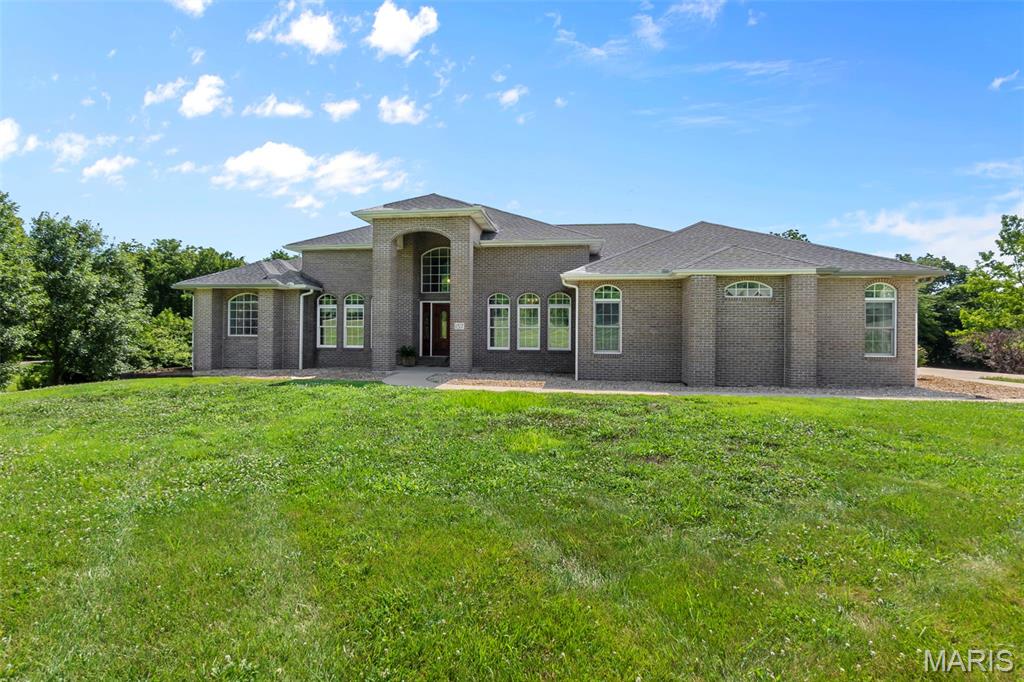 Welcome to 157 End Zone Road in Jackson on 3.28 acres in Touchdown Estates. This all-brick home offers 4 bedrooms, 4 bathrooms & over 3,500 sq ft of finished living space with more than 1,500 sq ft of unfinished area in the basement.  The main level features approximately 2,640 sq ft, a primary suite with two walk-in closets, double vanity (quartz), large sunken tub, oversized shower & private water closet.  The spacious kitchen has a breakfast bar, island with storage and stove top, stainless appliances, walk-in pantry & an open layout to the living room that centers around a gas fireplace. In addition you will see a formal dining room, formal living, office or library, half bath, laundry room, and 2 additional bedrooms with a Jack & Jill bath. There are 3 exits from the main level to access the covered deck.  The walkout basement includes a large living room that walks out to the in-ground pool, a full bath & and additional bedroom. Additional features include a 3-car garage, John Deere room, and the home sits on a cul de sac. This home blends comfort, space, and privacy!