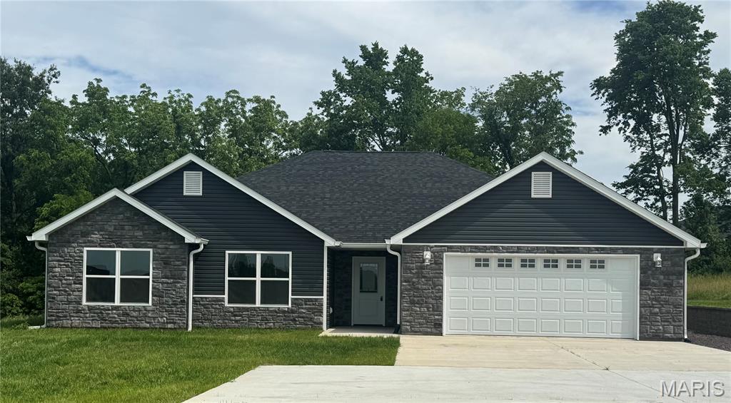Price just got better! Welcome to this beautiful new construction home in one of Hannibal’s newest subdivisions! Designed for easy main-level living, this open-concept home features vaulted ceilings and a bright, airy layout. The kitchen showcases white-on-white cabinetry, granite countertops, a full stainless steel appliance package, abundant cabinet space, and a walk-in pantry. A large center island offers seating and flows seamlessly into the separate dining area. The living room opens through sliding glass doors to an enclosed porch—perfect for plants, a cozy seating area, or quiet relaxation—with direct access to the back patio. Enjoy outdoor living on the stamped concrete patio accented with stone pillars and lighting. The primary suite includes a large walk-in closet and a private bath with a 5-foot vanity, shower, and linen cabinet. A rare bonus for slab homes in this area is the finished 17x12 storage room with 3-foot exterior doors—ideal for hobbies, storage, or equipment. The 2-car garage allows for easy parking and maneuvering. Located within city limits, this subdivision offers all city utilities and modern convenience in a growing neighborhood. Approx. 1/2 acre lot. Taxes have not been assessed.  Make your appointment today! #lovewhereyoulive