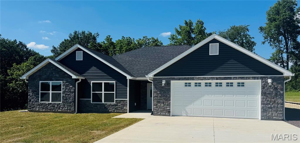 Price just got better! Welcome to this beautiful new construction home in one of Hannibal’s newest subdivisions! Designed for easy main-level living, this open-concept home features vaulted ceilings and a bright, airy layout. The kitchen showcases white-on-white cabinetry, granite countertops, a full stainless steel appliance package, abundant cabinet space, and a walk-in pantry. A large center island offers seating and flows seamlessly into the separate dining area. The living room opens through sliding glass doors to an enclosed porch—perfect for plants, a cozy seating area, or quiet relaxation—with direct access to the back patio. Enjoy outdoor living on the stamped concrete patio accented with stone pillars and lighting. The primary suite includes a large walk-in closet and a private bath with a 5-foot vanity, shower, and linen cabinet. A rare bonus for slab homes in this area is the finished 17x12 storage room with 3-foot exterior doors—ideal for hobbies, storage, or equipment. The 2-car garage allows for easy parking and maneuvering. Located within city limits, this subdivision offers all city utilities and modern convenience in a growing neighborhood. Approx. 1/2 acre lot. Taxes have not been assessed.  Make your appointment today! #lovewhereyoulive