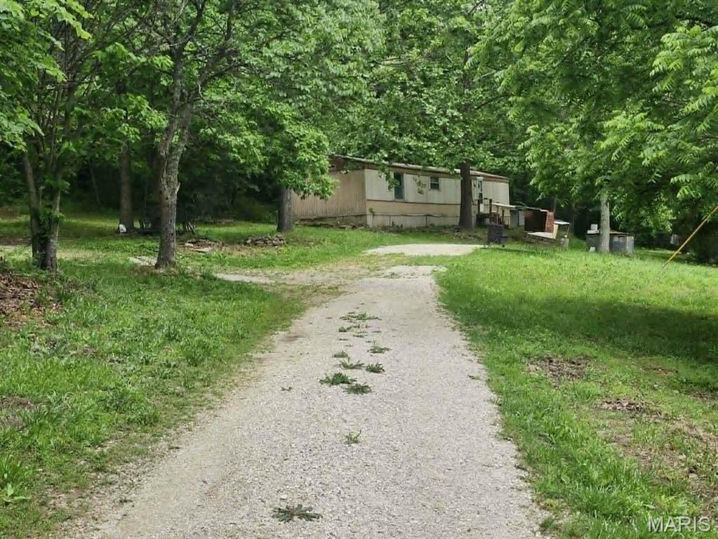 11 Acres with a 2 Bed, 2 Bath mobile Home. Property has a place for another dwelling, Power, Well, Private drive off of Hidden Valley. Come give this a look.