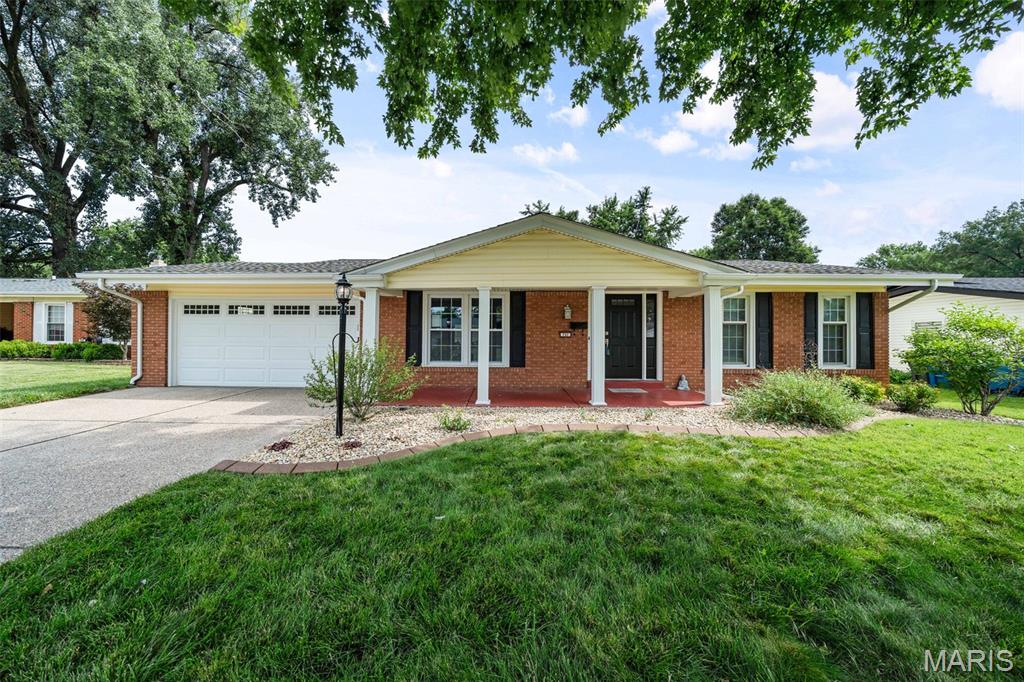 Welcome home to this beautifully maintained ranch offering incredible curb appeal, an inviting covered front porch, an attached two-car garage, and an exposed aggregate concrete driveway. Inside, you'll find hardwood flooring throughout the main level and a spacious, open floor plan designed for both everyday living and entertaining.

The kitchen features new countertops, abundant cabinetry, and opens seamlessly to the dining area and adjoining family room. Just off the kitchen, the cozy den with a wood-burning fireplace offers the perfect place to relax and features French doors leading to the beautifully landscaped, fully fenced backyard with an expansive paver patio—ideal for summer BBQs, morning coffee, or entertaining family and friends.

The main level offers three bedrooms and two full bathrooms, including a private primary suite with an ensuite bath and custom closet organization systems.

Downstairs, the finished lower level offers a spacious recreation area with endless possibilities—whether you envision a media room, playroom, home office, or additional family room. A separate dedicated gym, convenient half bath, laundry area, and plenty of storage complete the lower level.

The home has already passed the City of Hazelwood occupancy inspection, offering added peace of mind for its next owner.
This well-maintained home offers a functional floor plan, generous living space, and inviting outdoor living all in an established neighborhood just minutes from the elementary school, shopping, and major highways. Ready for its next owner to move in and enjoy!