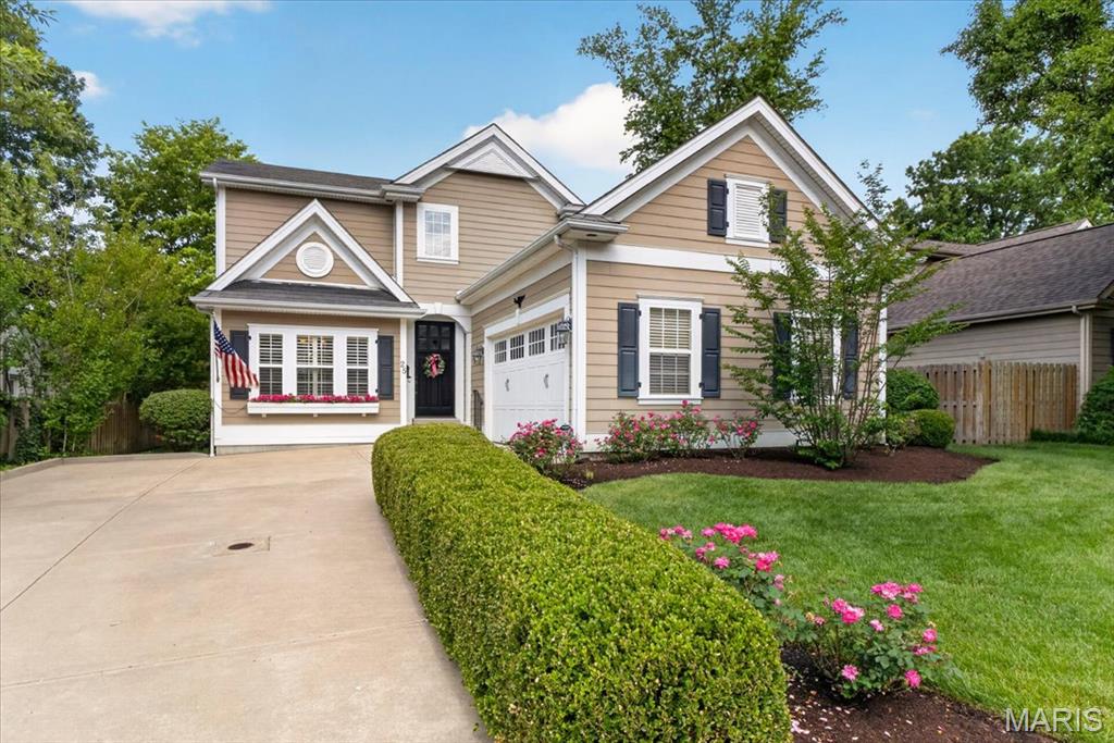 Perfectly situated in the heart of Ladue, this beautifully maintained two story home offers an exceptional blend of comfort, style, and convenience. Built in 2009 and lovingly cared for by its original owner, this residence welcomes you with a charming window box overflowing with flowers and timeless architectural details throughout. The elegant dining room features a coffered ceiling, wainscot molding, and plantation shutters, creating a warm and sophisticated setting for entertaining. The sought after main floor primary suite is complete with a charming bay window, a spacious walk-in closet, and a luxurious private bath. The thoughtfully designed floor plan also includes a convenient main floor laundry room, a charming powder room, and a gracious family room featuring beautiful built-in bookcases and a stunning stone fireplace and opens to the back yard area. The updated kitchen is truly the heart of the home, showcasing a large center island, high-end cabinetry, stainless steel appliances, solid surface countertops, and inviting spaces for everyday living and entertaining.  Upstairs, you will find three generously sized bedrooms and two full bathrooms, providing plenty of room for family and guests. The finished lower level offers additional living and recreation space along with a half bath, making it perfect for movie nights, a playroom, exercise area, or home office. Recent improvements include a brand-new roof, gutters, and downspouts, providing peace of mind for years to come. Located in one of Ladue's most desirable and central neighborhoods this exceptional home combines timeless design, meticulous care, and an unbeatable location close to shopping, restaurants, parks, and major highways.