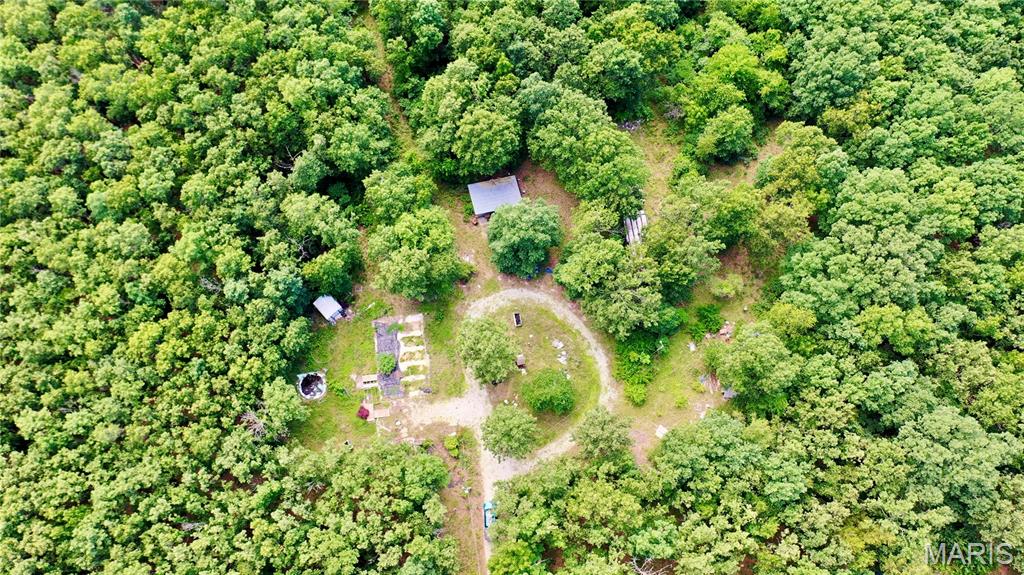 Opportunity awaits on this 8.8 surveyed, unrestricted acres located in the Oak Hill R-1 School District! Already equipped with a well, electric, and lagoon access, this property is ready for your future home, manufactured home, or multiple dwellings. A previous manufactured home site remains in place, making setup easy. The property also includes an older single-wide trailer of no assigned value, a storage shed, and a lean-to. With some cleanup and vision, this versatile property offers excellent potential for a homestead, rental investment, or multi-family setup. Enjoy the freedom of unrestricted acreage and make it your own!