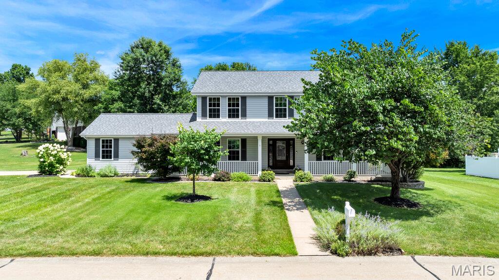 This Centrally Located Home is Ready for the Most Discriminating Buyer! YOU! With a Fabulous Wrap Around Porch & a Spacious  Driveway w/Side Entry Oversized Garage, 5 year old Double Hung Windows  thruout & Newer Exterior Doors. New Roof (less than a year) w/Architectural Shingles & a Ridge Vent.  Enclosed Soffits & Fascia. There is also a Newer Furnace and Air Conditioner. The Country Gourmet  Kitchen is a Chef's Delight w/Custom Built made Cabinetry from Quarter Sawn Oak from a Hermann Mo Barn and Glass from an 1800's Home in St. Louis Mo.  All inset Doors.  This Fabulous Portable Center Island is an Antique Work Bench that has been custom added. The Drawers are 3 feet (pulled out).  Farmhouse Kohler Deep Sink. Miele Dishwasher  w/Wood Front. Leathered Look Black Granite Countertops.  Convection Stove , Side by Side Refrigerator to Stay. All Bathroom Counters Feature Natural Quartzite. Primary Bath Includes Adult Height Vanity, Framed Mirrors, Double Sink, Separate Tub & Shower, Kohler Toilet & Travertine Stone Floor on the diagonal. There is Slate Stone in the Hall Bath. The Formal Living Room/Den & the Great Room and Separate Dining Room feature Walnut Stained Teak Hardwood.  There is Built in Shelving on the 2nd Floor Landing & More in the Laundry Room. The Rest of the Main Floor features Porcelain Tile.  This Large Lot Backs to a Lake (that you do not have to maintain) and Common Ground.  Large Spacious 20X16 Cedar Deck. There is a Fabulous View of the Lake from the 2nd Floor Bedroom. The Basement is Unfinished awaiting your ideas & Future plans. It has has a rough In for a future Bath. The Side Entry Garage is deep on one side (20X16). Ready for the Most Discriminating Buyer! YOU!