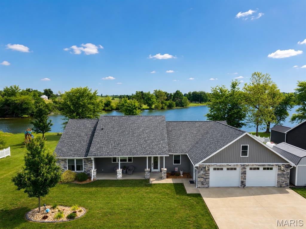 Welcome to this beautifully maintained 3-bedroom, 2-bath home located in the desirable Lake Hannibal community. Featuring a spacious open floor plan, this home offers comfortable living and effortless entertaining. The kitchen is a standout with elegant quartz countertops and plenty of workspace. Step outside to enjoy the fenced backyard complete with a composite deck and SunSetter awning — perfect for relaxing or hosting guests. The oversized two-car garage includes a dedicated workshop area plus additional storage above the garage with convenient stair access. Built on a slab foundation for low-maintenance living, this property combines functionality, comfort, and outdoor enjoyment in one exceptional package.