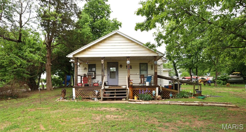 ***Great investment home*** on large corner lot. This 2 bedroom 1 bath home is awaiting its new owner. This could be a great retirement or rental home. There  is a ramp for easy entrance and deck on the front of the home.  The home has a large eat-in kitchen, huge storage area and laundry room at the back of the home. Home sits on 2 large lots and has mature trees surrounding it. Open area also for a garden or garage. Home has renters currently, please do not disturb them.