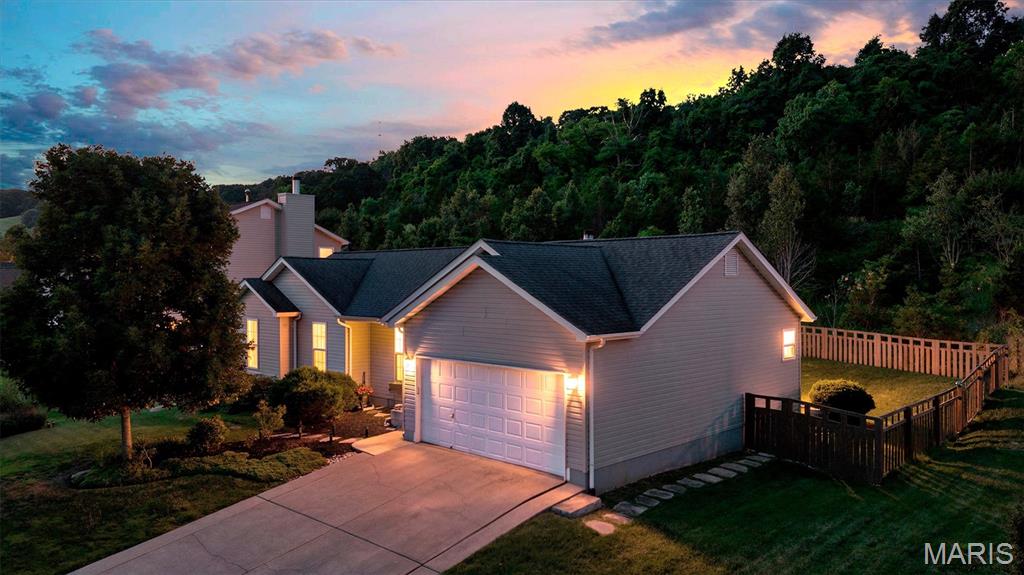 Tucked into a setting where nature and neighborhood charm meet, this beautifully maintained home offers 2,100+ square feet of finished living space and a lifestyle designed for both relaxation and connection. Backing to common ground and surrounded by frequent wildlife sightings, the fenced backyard creates a private retreat where mornings begin with birdsong and evenings are spent unwinding on the patio.

Inside, vaulted ceilings and abundant natural light create an airy, welcoming atmosphere throughout the main living spaces. Rich hardwood floors add warmth and character, while the wood-burning fireplace serves as the heart of the home—perfect for gathering with family and friends during cooler seasons.

The kitchen and living room flow seamlessly together beneath soaring ceilings, creating an ideal environment for everyday living and entertaining alike. Main-level laundry adds convenience, while the thoughtful floor plan provides comfortable living across every level.

The primary suite offers a peaceful escape at the end of the day, featuring a spacious bath complete with a soaking tub, separate shower, and double-bowl vanity designed to make busy mornings feel effortless.

The finished lower level expands the home's versatility with a full bath, wet bar, and generous recreation space ready to accommodate game days, movie nights, hobbies, fitness equipment, or overnight guests.

For those who appreciate an active lifestyle, Sugar Creek Golf Club is just a short walk or golf cart ride away, making it easy to enjoy a round of golf, meet friends, or simply take in the beauty of the surrounding landscape.

Combining natural beauty, functional living spaces, and a location that encourages both recreation and relaxation, 2253 Fairway offers the opportunity to enjoy every season of life from a place that truly feels like home.
