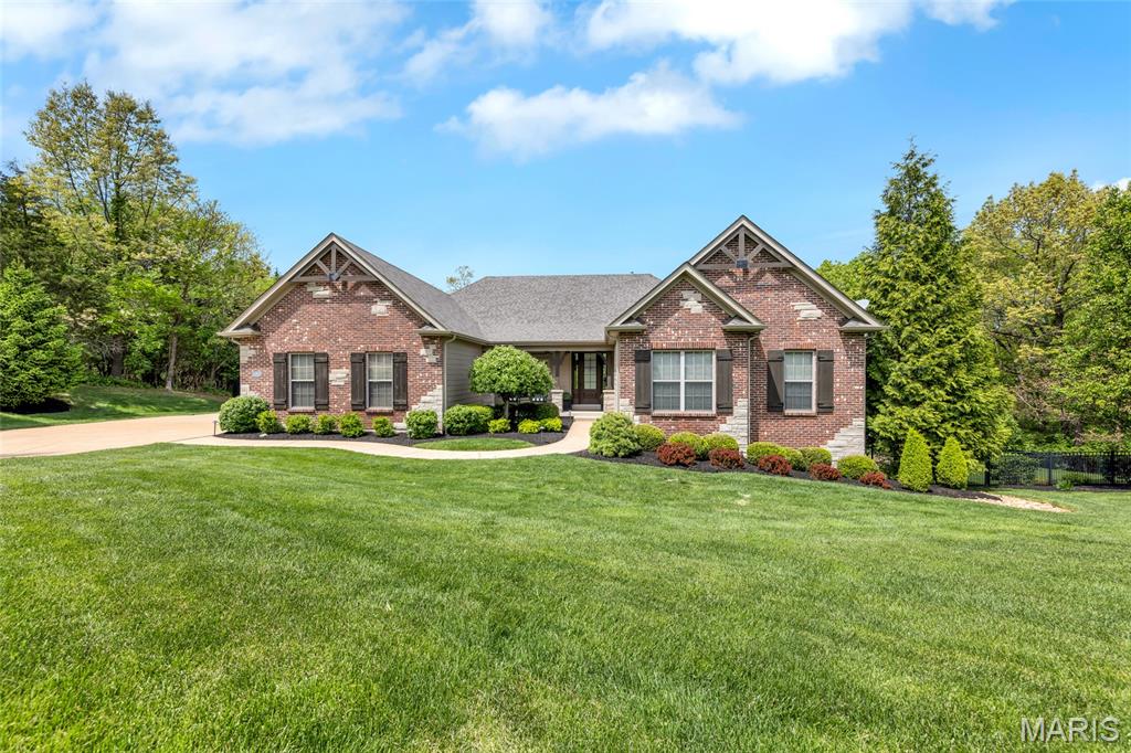 Welcome to 1707 Shepard Road. Experience refined living in this stunning Fischer & Fritchel 4 bedroom, 3.5 bath ranch nestled on 3.09 private acres with 4,000 sq. ft. of beautifully finished living space. From the moment you arrive, the stately curb appeal sets the tone for the thoughtful design within. The foyer features rich hardwoods that expand throughout the home and opens to a formal dining room distinguished by wood beamed columns, while the expansive great room boasts custom entertainment center and built-in speakers and abundant natural light flowing through the vast window wall. The open concept chef’s kitchen impresses with a generous center island, stainless steel appliances, double wall ovens, stone counters, high end cabinetry and a walk in pantry, seamlessly connecting to the breakfast room with deck access, and a warm hearth room anchored by a stone gas fireplace. The primary suite is a luxe retreat with spacious, dual walk in closets, double vanities and a substantial, spa like tiled shower. Two additional bedrooms serviced by a full bath, large mudroom with laundry and a powder room complete the main level. The walk out lower level is ideal for entertaining and features a large family room, a full wet bar, as well as a guest bedroom with walk in closet, full bath, home gym area and ample unfinished space for storage or additional expansion. Enjoy the secluded, tree lined backyard while relaxing on the platform deck or lower patio area. An oversized, side entry 3 car garage, pristine landscaping, partially fenced yard and lawn irrigation completes this exceptional home. With upscale finishes throughout and every detail carefully considered, this meticulous residence offers comfort, luxury and location. Fabulous opportunity within the award winning Rockwood School District.