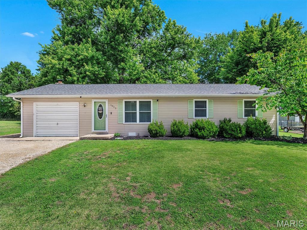 NOW AVAILABLE - CHARMING 3 Bedroom /1 Bath home with new roof (1-year old), attached Garage, and large Fenced Yard in a quiet neighborhood and within walking distance of school! Home features stainless appliances, a small kitchen table/island, and updated vinyl plank flooring.  Everything you would want in a cozy and cute starter home, OR for downsizing with no-step entry and affordable utilities!  The garage has multipurpose use with a television and shelving, while still leaving plenty of room for a car when not used for a workshop or entertaining.  The backyard features a paver patio, outdoor soffit lighting, a shed, and it extends beyond the fenced yard to the tree line for a little bit of quiet scenery and additional play space.  Schedule your appointment to see this home today!  OFFERS ACCEPTED THROUGH SUNDAY, 5/31/26