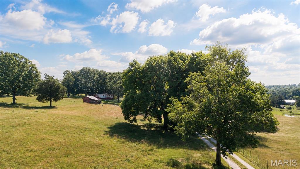 Welcome to your 21 acres of your own farm, recreation place, perfect place for your horses, or just call it home! This place has a doublewide home that has Livingroom, eat in Kitchen with country kitchen cabinets, 2 bedrooms, laundry room, and walk in shower bathroom. All of this sits on a full walkout basement. The basement has access from the main floor with a ladder set of stairs. Owner had used the basement for workshop, TV room, exercise area, storage and many other possibilities. There is a 2 car carport off the end by the basement by the walk out door. Circle driveway! But the best part is the land. Partial fenced pastures with gate at the beginning of the beautiful driveway! A must see to appreciate. Barn has a lean-to and a stall but does need attention. There's additional trailer that was used for storage and will stay on the land with the sale. Any other outbuildings will stay unless sold before closing or negotiated in the contract.