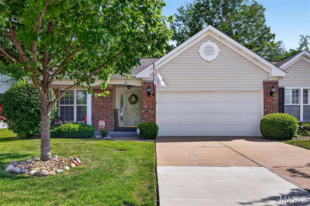 Welcome home to 30 Hunting Manor Drive, a beautifully maintained villa tucked away on a quiet cul-de-sac in the highly desirable Huntington Manor community. This inviting home offers easy main-floor living with a spacious open floor plan, soaring vaulted ceilings, rich hardwood flooring, and an abundance of natural light throughout. The great room flows seamlessly into the bright breakfast area featuring a bay window and access to the private deck—perfect for morning coffee or relaxing evenings overlooking the peaceful backyard.

The kitchen is both functional and stylish with ample cabinetry, updated backsplash, and plenty of workspace for everyday living and entertaining. The split-bedroom design provides privacy, with a spacious primary suite featuring a walk-in closet and private bath. A second bedroom, full hall bath, and convenient main-floor laundry complete the main level.

The finished lower level expands your living space with a large recreation area, additional bathroom, and plenty of storage. Enjoy low-maintenance villa living with lawn care and exterior upkeep included, all while being just minutes from shopping, dining, parks, and easy access to Highways 94, 364, and 70. A rare opportunity to own a move-in-ready villa in one of St. Charles County's most sought-after communities!
