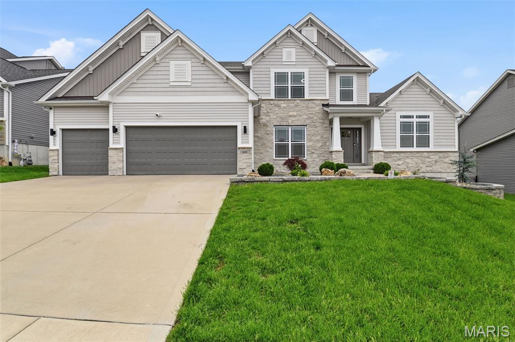 Exceptional custom-built 2 story home offering over 3,332 finished sq ft and only five years old. This 4-bedroom, 3.5 bath residence features high end craftsmanship, generous room sizes, and a functional layout designed for modern living. The main level includes a chef’s kitchen with an oversized center island, extensive custom cabinetry, premium finishes, and abundant prep space. The kitchen opens to the dining area and a hearth-style breakfast/sitting room with a two sided fireplace shared with the main living room. The main level also features a spacious primary suite with tray ceilings, an oversized designer ceiling fan, and three closets including a large walk in. The ensuite bath includes dual vanities, a walk in shower, and a soaking tub. Three additional oversized bedrooms and two full bathrooms complete the upper level, along with a large flex room ideal for recreation, play or media. The finished lower level includes a stylish wet bar with granite countertops and a pull drawer microwave, a large living area, private office, additional bedroom, ¾ bath, and an unfinished gym area. Ample storage space remains for future customization. Outdoor features include a 16x33 Trex maintenance free deck, new 24 ft concrete patio, professionally landscaped yard, sprinkler system, and designer exterior lighting on timers. 3 car garage, architectural details, access to community pool and park, and low HOA dues of $1,093 annually.