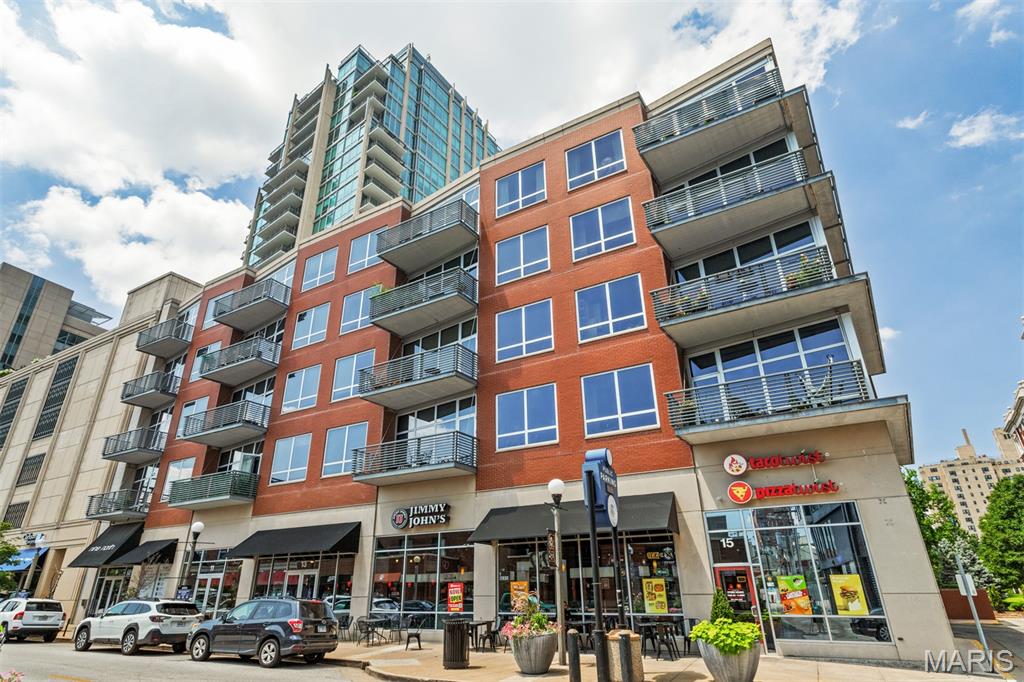 This absolutely stunning corner condo with gleaming dark wood floor-to-soaring ceiling windows offers unobstructed city views and wrap-around balconies in 3 cardinal directions, defining a top-floor lifestyle in the lovely Central West End of St Louis. Composed of 1600+ square feet, this home hosts 2 bedrooms and 2 full baths plus an additional office with custom-built bookshelves and additional storage. Enter the gracious, combined dining and living areas that epitomize fabulous flow, comfort and natural light. The grand granite island defines both form and function, and serves as the spot to gather while the chef makes the most of a kitchen outfitted with hand-made tile backsplash, wine fridge, and plenty of counter space and storage. This main area balcony has room to retire with guests, and overlooks expansive north and west views. A loaded primary suite has fabulous views and a balcony of its own, and includes a dual vanity plus walk-in closet, and in-unit laundry.  A second sun-filled bedroom is privately tucked toward the rear, along with a hall bath with combined tub and shower. As grand and light as it all is, custom blinds and black-out curtains turn this sky-high space into a cozy retreat at the flip of a switch and the draw of a drape. The amenities include 2 side-by side assigned parking spaces, a pool with a fabulous patio, a gym, an additional storage container, and perhaps the most walkable location in the Central West End; just steps to Forest Park, BJC, Wash U, and  all the top restaurants, bars ad lunch spots an urban dweller could desire. Come experience this one-of-a-kind home today!
