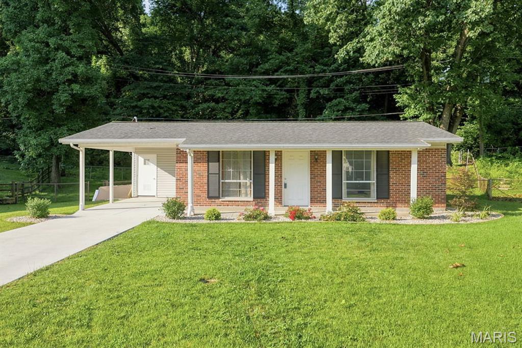 Welcome to this well-maintained, move-in-ready property featuring modern updates and easy, step-free access from both the front and rear entrances. The home offers a beautifully updated kitchen complete with an electric stove, dishwasher, and garbage disposal, along with an updated bathroom featuring a convenient walk-in shower conversion. Enjoy comfortable living with ceiling fans in the living room and primary bedroom, plus spacious double closets in both bedrooms for ample storage. A newer vinyl sliding door opens to the patio, creating a seamless transition to the fully fenced backyard which is perfect for relaxing, entertaining, or pets. Recent exterior improvements include a newer concrete driveway, carport, and patio, all installed with enhanced drainage for added peace of mind. The newly landscaped front yard adds great curb appeal, making this charming home as inviting outside as it is inside.