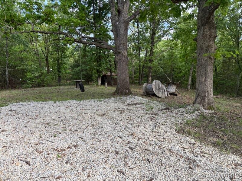 Great opportunity to own a versatile lot with endless potential. This property features a huge gravel driveway with turnaround and tree swing making it ideal for immediate recreational use or future development. Whether you're looking for a weekend getaway spot, a place to store your outdoor gear, or the perfect site to build your dream home with mature Oak Trees, this lot offers the flexibility to fit your needs and comes with access to all four lakes. Enjoy the peaceful open setting and the freedom to use the property for recreation today while planning for residential construction in the future.
located in Lake St Clair subdivision. Lake St. Clair is a private, Franklin County, Missouri community and is located approximately 1 mile west of the City of St. Clair, Missouri off of Missouri Highway PP.  Developed in the early 60’s by Authorized Investors Group the community consists of 450 acres of land, with 1352 lots and twenty three miles of road.  The highlight of the community are the four lakes found within the subdivision.

 The main lake, Lake #1, covers approximately 60 acres and is used primarily for recreation such as boating, skiing, fishing and other water sports.  At one end of Lake #1 is a marina and boat launch.  At the other end of Lake #1 you will find a public beach for non-waterfront owner’s use.  Lakes 2, 3, and 4 also are used for recreational purposes however only trolling type motors are allowed on these three lakes.  

A rare chance to own a property that combines convenience, functionality, and opportunity! There are no electric, water or sewer utilities on the property but nearby. In the 80's the subdivision received a federal-state grant to install and operate a sewer district.  Along with the Franklin Count Water Company and Ameren Missouri the subdivision has full infrastructure in place to support the 322 homes that are now within the community. Property owners also pay a sewer assessment levied by the Lake St Clair Sewer District.  Property owners desiring access to water have an option of drilling a well or contracting with the Liberty Water company. The development is managed by five trustees, who are elected by those property owners Yearly assessments.