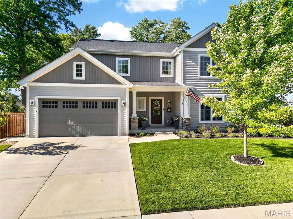 Why wait to build when you can move right into this exceptional 5-year-old custom 1.5-story home by Lewis Homes that shows like new and is loaded with quality upgrades throughout? Ideally located just blocks from Keysor Elementary, Kirkwood Park, and the shops, restaurants, and entertainment of vibrant Downtown Kirkwood, this 4-bedroom, 3.5-bath home offers the perfect combination of luxury, comfort, and convenience. A welcoming foyer opens to an elegant dining room featuring crown molding and custom millwork. The open-concept floor plan showcases 9-foot ceilings, hardwood floors throughout the main level, and abundant natural light. The gourmet kitchen is beautifully appointed with custom cabinetry, granite countertops, stainless steel appliances, and an oversized center island with seating, seamlessly flowing into the breakfast area and spacious great room highlighted by a gas fireplace with a custom mantel. Just off the attached two-car garage, the mudroom with custom built-in cubbies and bench creates the perfect everyday drop zone and is complemented by a convenient main-floor laundry room. The luxurious main-level primary suite features a custom walk-in closet by St. Louis Closet Co. and a spa-inspired bath with dual vanities, an oversized tiled shower, and an Aquatic jetted tub. Upstairs, two generously sized bedrooms share a full bath, providing comfortable accommodations for family or guests. The professionally finished lower level with 9-foot ceilings offers exceptional additional living space, including a large recreation room, fourth bedroom, full bath, and abundant storage. Step outside to enjoy the private, fenced backyard featuring a spacious 24' x 15' patio—perfect for entertaining, outdoor dining, or relaxing. This meticulously maintained home offers all the benefits of new construction without the wait in one of Kirkwood's most desirable neighborhoods.