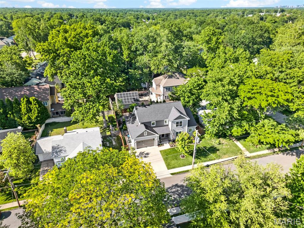 Move-in ready and offering the perfect blend of timeless style and modern convenience, this beautifully crafted 5-year-old custom home is ideally located just blocks from Keysor Elementary, North Middle School, Kirkwood High School, Kirkwood Park, and the shops, restaurants, and entertainment of vibrant Downtown Kirkwood. Featuring 4 bedrooms, 3.5 baths, and exceptional finishes throughout, this meticulously maintained home is better than new. A welcoming foyer opens to a versatile flex space that can easily serve as a home office, formal dining room, or music room, allowing you to tailor the home to your lifestyle. The open-concept floor plan showcases 9-foot ceilings, rich hardwood floors throughout the main level, and an abundance of natural light. The gourmet kitchen is designed for both everyday living and entertaining, featuring custom cabinetry, granite countertops, stainless steel appliances, and an oversized center island with seating. It flows seamlessly into the breakfast room and spacious great room, highlighted by a gas fireplace with a custom mantel. Conveniently located off the attached two-car garage, the mudroom offers custom built-in cubbies and a bench, creating the perfect everyday drop zone, while the adjacent main-floor laundry room adds to the home's thoughtful functionality. The luxurious main-level primary suite serves as a private retreat with a custom walk-in closet by St. Louis Closet Co. and a spa-inspired bath featuring dual vanities, an oversized tiled shower, and an Aquatic jetted tub. Upstairs, two spacious bedrooms share a well-appointed full bath. The professionally finished lower level with 9-foot ceilings provides exceptional additional living space, including a large recreation room, fourth bedroom, full bath, and abundant storage. Step outside to the private, fenced backyard where a spacious 24' x 15' patio creates the ideal setting for entertaining, outdoor dining, or simply relaxing. Offering the quality and amenities of new construction without the wait, this exceptional home is a rare opportunity in one of Kirkwood's most sought-after neighborhoods.