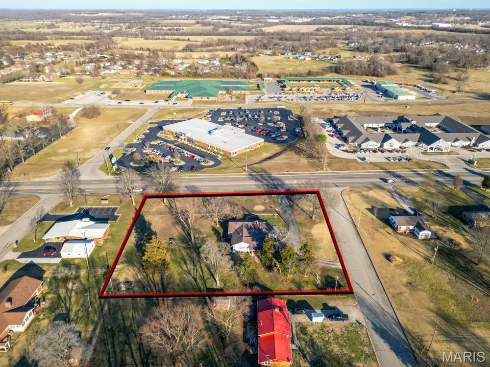 RARE COMMERCIAL OPPORTUNITY WITH HIGH VISIBILITY AND VERSATILE USE POTENTIAL! Situated on approximately 1.5 acres with excellent highway frontage, this well-maintained property offers outstanding exposure and accessibility, making it ideal for a variety of commercial or mixed-use applications. The existing 3-bedroom, 2-bath brick structure provides a solid, adaptable footprint that can be easily converted to office, retail, or service-based use, while still accommodating residential occupancy if desired. The building features multiple spacious interior areas suitable for private offices, conference rooms, or customer-facing spaces. A central living area with a fireplace and built-in shelving creates a natural focal point, ideal for a reception area or collaborative workspace. Large windows throughout the property allow for abundant natural light, enhancing the overall professional atmosphere and reducing the need for artificial lighting during business hours. Exterior features include a generous lot with room for expansion, additional parking, or outdoor business use. The fenced portion of the property adds security and flexibility for storage or designated activity areas. With strong curb appeal, durable construction, and a highly functional layout, this property presents an exceptional opportunity for investors, business owners, or developers seeking a high-visibility location with immediate usability and long-term potential.