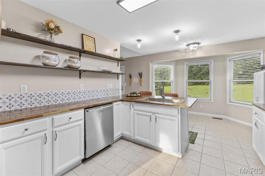 Beautifully maintained home located in the desirable Farmington School District, offering space, comfort, and scenic surroundings. Situated on a beautiful, level 3 acres, this property provides the perfect blend of open space and privacy. The custom remodeled kitchen is a true showpiece, featuring warm acacia butcher block countertops, updated finishes, and a thoughtfully designed layout that blends style and functionality. The inviting living room features a cozy propane fireplace and large rear-facing windows that showcase peaceful views—perfect for enjoying wildlife, outdoor gatherings, or quiet evenings. The main level includes 3 bedrooms and 2 full baths, highlighted by a spacious primary suite with a large walk-in closet and private bath. The finished walk-out basement adds incredible flexibility with an additional bedroom and full bath, offering the potential for a separate living space or in-law suite—with room to expand into a full kitchen area if desired. Car enthusiasts or hobbyists will love the impressive 30x50 detached garage, already plumbed for an additional bathroom and featuring an oversized door ideal for RV storage.
Step outside and enjoy a beautiful setting complete with multiple mature fruit trees (apple, pear, peach, & cherry), creating the perfect backdrop for gardening, wild life watching, outdoor entertaining, or relaxing around a fire pit. Located in a highly sought-after area—this is truly a must-see property.