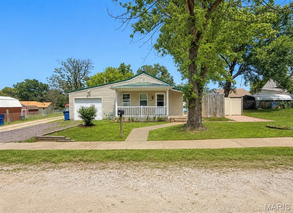 Welcome home to this charming single-story ranch that perfectly blends comfort, convenience, and affordability! Whether you’re searching for your very first home, looking to downsize, or simply wanting a low-maintenance property, this inviting two-bedroom, one-bathroom home offers everything you need to settle in and enjoy. Step inside and discover a warm, cozy atmosphere that immediately feels like home. The thoughtfully designed floor plan provides comfortable living spaces that are both functional and welcoming, making it easy to relax after a long day or entertain family and friends. The spacious kitchen and dining combination creates the perfect gathering place for everyday meals, holiday celebrations, or morning coffee. With plenty of cabinetry, generous countertop space, and an open layout, you’ll appreciate the convenience and practicality this area has to offer. The home also features a generously sized laundry room, providing ample space for storage, organization, and everyday household tasks. It’s a practical feature that adds to the home’s overall functionality while making daily routines more convenient. Both bedrooms offer comfortable accommodations with plenty of natural light, creating peaceful retreats for rest and relaxation. The full bathroom is conveniently located and designed to serve both bedrooms with ease. Outside, you’ll find even more reasons to fall in love with this property. Start your mornings on the welcoming covered front porch, the perfect spot to enjoy a cup of coffee while taking in the peaceful surroundings. You’ll appreciate the private patio area, offering a secluded setting that’s ideal for grilling, entertaining guests, or simply unwinding in your own outdoor oasis. Additional features include an attached one-car garage that provides secure parking while offering extra storage space for tools, lawn equipment, or seasonal items. This home delivers the perfect balance of comfort, charm, and practicality. Its cozy setting makes it easy to feel right at home from the moment you walk through the front door. Whether you’re just beginning your homeownership journey or searching for a property that’s easy to maintain, this ranch-style home checks all the boxes. Don’t miss your opportunity to own this wonderful property that combines comfortable living, functional spaces, inviting outdoor areas, and an excellent layout—all wrapped into an affordable package that’s ready for its next owner. Schedule your private showing today and see everything this delightful home has to offer!
