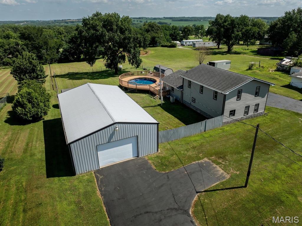 This home sits on over two acres, has a 30x50 OUTBUILDING with plenty of room to store all your toys, 10x10 SHED, a POND, plus a large deck that wraps around the POOL - perfect for all your summer gatherings! Featuring FIVE BEDROOMS, two bathrooms plus an additional half bathroom for guests there is more than enough room for everyone to stretch out! Downstairs you will find a large living room, recently renovated kitchen, designated dining space, half bathroom and large laundry room. Finishing off the main level is the large primary suite complete with a walk-in closet, primary bathroom, plus bedroom number two. Moving upstairs you will find a large loft area perfect for a second living room, three more bedrooms, and a full bathroom. This one is a crowd pleaser for everyone in the family!