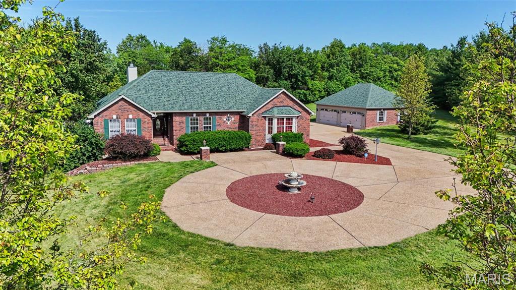 Welcome to 103 Talon Court in Wentzville—where space, updates, and lifestyle come together beautifully. Situated on 3 acres, this exceptional property offers both privacy and functionality with an impressive 4-car attached garage plus an additional 4-car detached garage—perfect for car enthusiasts, hobbyists, or extra storage needs.
This home has been thoughtfully updated with fresh paint, a brand-new air conditioning system, and a new roof and gutters all completed in 2025, giving buyers peace of mind for years to come.
Step outside and experience true resort-style living with an inground heated pool, hot tub, and an incredible outdoor entertainment area—ideal for hosting gatherings or simply relaxing in your own private retreat.
Inside, the home is perfectly suited for multi-generational living. The finished lower level features a full kitchen, additional living area, bathroom, and sleeping space—offering comfort, flexibility, and independence for extended family or guests.  Offered at $760,000, this property delivers a rare combination of acreage, amenities, and versatility in a highly desirable location. Don’t miss your opportunity to own this one-of-a-kind home!