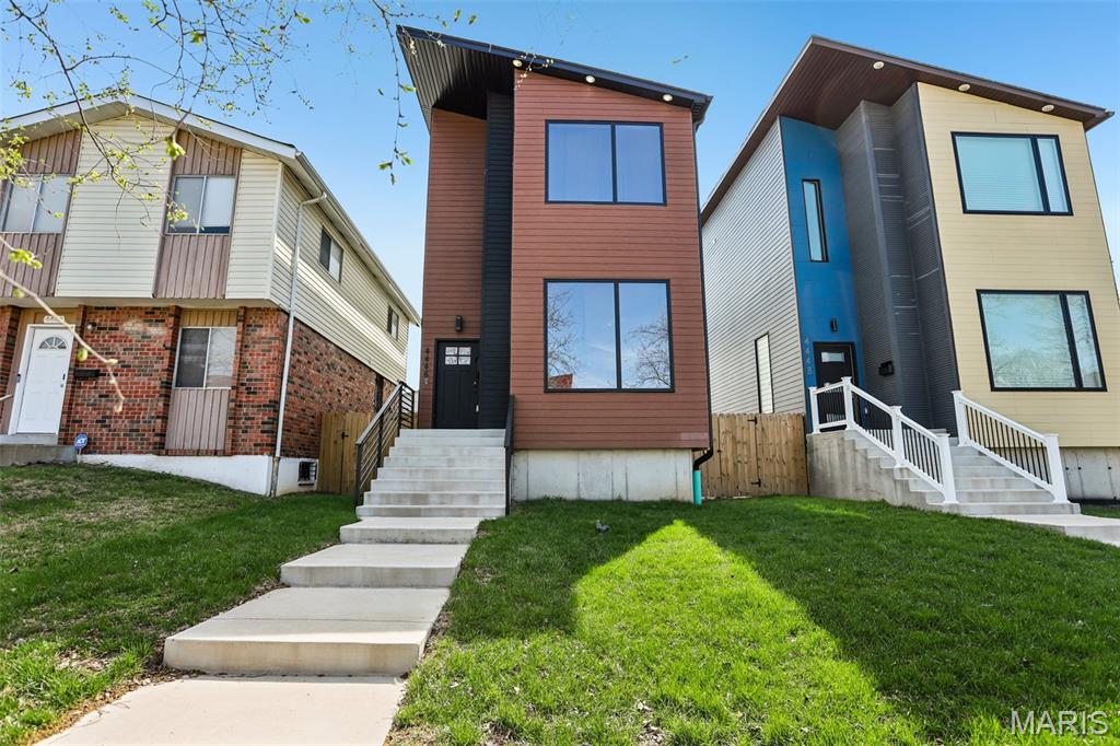 Experience modern luxury in the Grove neighborhood with this custom 4-bedroom, 3.5-bath home built in 2024. A 5-minute drive from Barnes Jewish Hospital with easy access to highways (64 and 44), this home is perfect for any working professionals. From the moment you enter, the dramatic floating staircase and soaring 10-foot ceilings create a grand, open atmosphere filled with natural light from the home’s oversized windows.   The kitchen featuring a 10-foot quartz waterfall island, built-in wall oven, and the ideal layout for entertaining and everyday living. The open-concept design seamlessly connects the kitchen, dining, and living spaces.   Upstairs, enjoy 10-foot ceilings that continue the home’s airy and luxurious aesthetic. The oversized primary suite offers a true retreat with a spa-inspired bathroom complete with a curbless shower and a custom-organized closet. Generously sized secondary bedrooms and oversized closets throughout provide both comfort and functionality.   The finished basement adds valuable additional living space perfect for a media room, fitness area, or entertainment space. The downstairs bedroom and full bath offer guests both privacy and comfort. Outdoors, the deck space and fenced backyard create a private setting, perfect for relaxing or hosting gatherings.