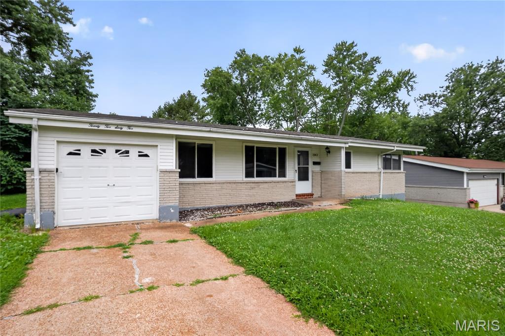 Welcome to 2262 Crandel Drive, a classic 4-bedroom, 2-bathroom single-family brick ranch offering 1,408 square feet of main-level living space.

The entry opens into a spacious living room configuration highlighted by original hardwood flooring that runs throughout the primary main-level spaces. The floor plan connects to a functional kitchen area equipped with custom cabinetry and a layout designed for daily food preparation and storage efficiency. All four bedrooms are located on the main level, providing simple single-story accessibility, including a primary bedroom with an attached full bathroom alongside a second full hallway bathroom.

The property features a finished basement footprint that significantly expands the usable square footage, complete with a dedicated workshop and hobby area, utility hookups, and additional open space for storage or recreation. Exterior amenities include an attached 1-car garage with an automatic door opener, off-street driveway parking, a private rear concrete patio space, and a level 0.18-acre fenced backyard. Conveniently located in the Hathaway Manor subdivision, this property offers straightforward proximity to local Hazelwood public schools, community parks, and regional transit corridors.