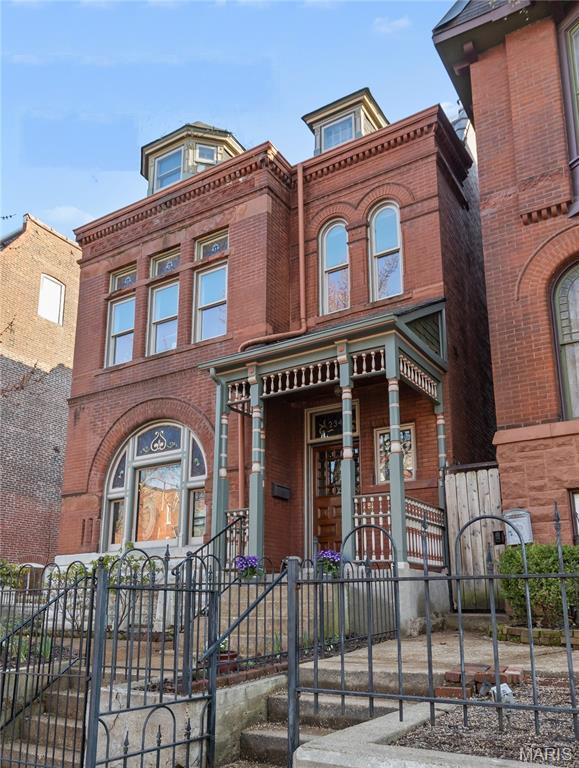 Three new high-efficiency HVAC systems to be installed 7/17-7/21!! Updated, Victorian mansion on a impressive, double lot only steps from Lafayette Park. Abundant, historic, and architectural details with quality updates. From the very start you will be charmed by the iron fence which highlights, elevates, and secures the landscaped front yard. Ornate, freshly painted wood trim, brick and stonework enhance a delightful, covered front porch. Original refinished wood entry door with beveled panes and art glass light up the spacious entry foyer. Main level features a formal living room with wood floors, original fireplace, built-in bookcases and crown molding. Impressive dining room with pocket doors, two-tone premium colors with beautiful decorative chair rail, period lighting, original fireplace, and built-in glass curio cabinet. Amazing new kitchen with Aston Green, wood, soft-close, premium cabinetry, new stainless steel appliance package including a 6-burner stove with hood, built-in warming drawer, a huge island with undermount sink and built-in dishwasher all made for entertaining and enjoying every day. Can't say enough about how nice this kitchen is with luxurious granite counters, built-in secret storage, stained glass, and lots of extra room with a breakfast bay. So much delightful light from so many windows and the essential updated 1st floor half bath! Back door off kitchen opens to a impressive deck and overlooks the landscaped grounds, two car garage, and two additional private off-street parking spaces. 2nd floor has plush new carpeting running up the elegant staircase across the open hallway and back into the exquisite guest bedroom with a bay window. Spacious primary suite features a primary bath with double vanity, oversized jetted tub and shower, walk-in closet, and an attached extra room for a den or office. Hall bath on second floor has an equipped laundry closet and skylight. Third floor features two additional bedrooms, an updated full bath, and an extra room for making your dreams come true. No scary city basement here: tall ceilings, light, bright, and polished for so much quality space for a gym, workshop, storage, and so much more.  You will love: new roof, insulated windows, and updated electric but most of all you will love the location on a quiet cul-de-sac street in the heart of the Square. Come be a part of the neighborhood! Walk to dinner every night with a pleasant stroll through the magical park! Be here for the park concerts, movies, bike races, and so many events that make Lafayette Square city living the best.