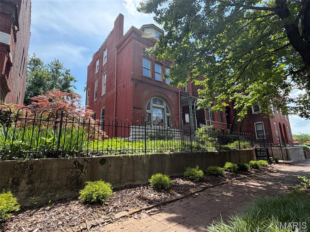 Updated, Victorian mansion on a impressive, double lot only steps from Lafayette Park. Abundant, historic, and architectural details with quality updates. From the very start you will be charmed by the iron fence which highlights, elevates, and secures the landscaped front yard. Ornate, freshly painted wood trim, brick and stonework enhance a delightful, covered front porch. Original refinished wood entry door with beveled panes and art glass light up the spacious entry foyer. Main level features a formal living room with wood floors, original fireplace, built-in bookcases and crown molding. Impressive dining room with pocket doors, two-tone premium colors with beautiful decorative chair rail, period lighting, original fireplace, and built-in glass curio cabinet. Amazing new kitchen with Aston Green, wood, soft-close, premium cabinetry, new stainless steel appliance package including a 6-burner stove with hood, built-in warming drawer, a huge island with undermount sink and built-in dishwasher all made for entertaining and enjoying every day. Can't say enough about how nice this kitchen is with luxurious granite counters, built-in secret storage, stained glass, and lots of extra room with a breakfast bay. So much delightful light from so many windows and the essential updated 1st floor half bath! Back door off kitchen opens to a impressive deck and overlooks the landscaped grounds, two car garage, and two additional private off-street parking spaces. 2nd floor has plush new carpeting running up the elegant staircase across the open hallway and back into the exquisite guest bedroom with a bay window. Spacious primary suite features a primary bath with double vanity, oversized jetted tub and shower, walk-in closet, and an attached extra room for a den or office. Hall bath on second floor has an equipped laundry closet and skylight. Third floor features two additional bedrooms, an updated full bath, and an extra room for making your dreams come true. No scary city basement here: tall ceilings, light, bright, and polished for so much quality space for a gym, workshop, storage, and so much more.  You will love: new roof, insulated windows, and updated electric but most of all you will love the location on a quiet cul-de-sac street in the heart of the Square. Come be a part of the neighborhood! Walk to dinner every night with a pleasant stroll through the magical park! Be here for the park concerts, movies, bike races, and so many events that make Lafayette Square city living the best.