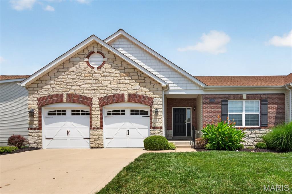 Welcome to Mill Ridge and this Chesterfield villa offering 1,741 sq ft of low-maintenance living! The striking brick and stone exterior creates standout curb appeal, while the vaulted ceilings and dramatic wall of windows fill the open floor plan with natural light. An oversized great room seamlessly flows into the dining area, creating the perfect space for everyday living and entertaining. The kitchen features 42” cabinetry, pantry, breakfast bar, and adjoining breakfast room with sliding glass door leading to the deck.  The spacious primary suite boasts crown molding, new lighted ceiling fan, a large walk-in closet, and private bath with oversized vanity, shower, and linen closet. A generously sized secondary bedroom offers lighted ceiling fan, ample closet space, and easy access to the second full bath. Main floor laundry with built-in shelving adds convenience and connects directly to the kitchen and attached 2-car garage. The expansive lower level offers endless possibilities with 3 egress windows, abundant storage, and space for a future recreation room and third bedroom. Recent updates include interior paint and new flooring! Enjoy carefree living with the association covering lawn care, roof, siding, driveway, sidewalks, and street maintenance. All this in an unbeatable Chesterfield location near shopping, dining and Creve Coeur Park!