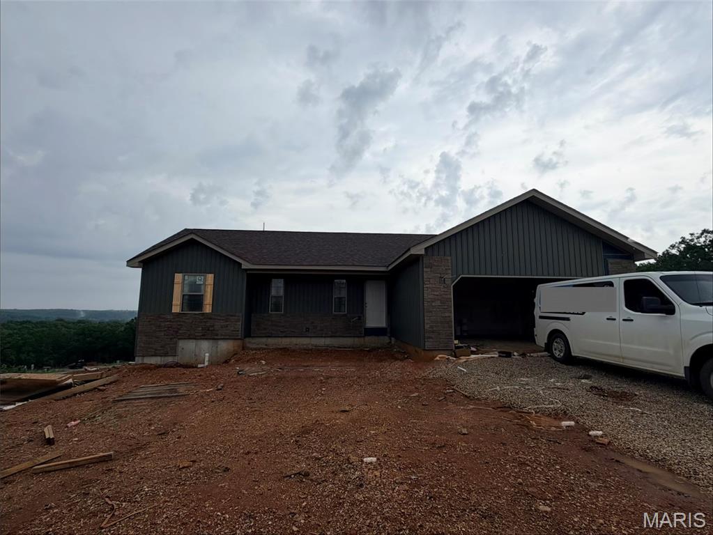 Welcome home to this Ozark model new construction home, with estimated completion of July 2026! Situated in the Summit Pass subdivision, just minutes from the West gate of Fort Leonard Wood, this home features an open concept living space, with luxury vinyl plank flooring throughout. In the kitchen, find granite counter tops, stainless steel appliances, along with custom cabinetry, including hickory center island, gold finishes & soft close drawers. Living area provides access to the covered deck. The primary suite includes tile shower & glass door, as well as spacious walk-in closet. Main floor laundry is conveniently located off the garage. One additional bedroom & full bathroom round out the main floor. Downstairs, find a family room with access to the backyard, two bedrooms & bathroom, along with a large storage room. All bathrooms include white vanities. Main floor common bath and lower level bath both include tub/shower combo. Home includes spray foam insulation, Carrier heat pump HVAC system, solid surface flooring, Owens Corning shingles & insulated garage doors. One year Builder's Warranty included.