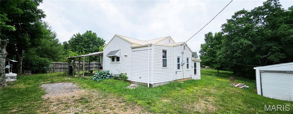 This small bungalow sits on just under 1.5 acres that the seller fenced for their horses and donkeys. The house needs some work to polish it up but has several high-ticket improvements in place such as newer metal roof, newer vinyl windows, and private well.  The detached garage/shop makes good covered parking and a great hobby or workshop area. Price is negotiable so act now if you're looking for a budget friendly location in a rural area that would be great for animal lovers!