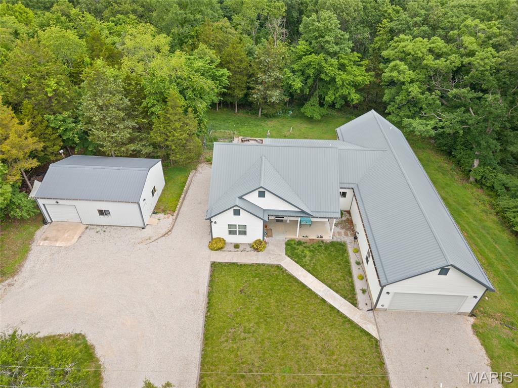Discover the perfect blend of modern luxury and serene country living in this exceptional 7-year-old ranch estate. Spanning 2,829 square feet on 4.07 private acres, this home was engineered for longevity and efficiency using the premium ZIP System and a lifetime metal roof with snow guards.

Step inside to an expansive open-concept layout where natural light pours through large windows. The gourmet kitchen is a chef’s dream, boasting custom cabinetry, sleek quartz countertops, a massive center island, and a spacious walk-in pantry. The living area flows seamlessly to an oversized deck—your front-row seat to peaceful views of the rolling property and dense woods beyond.

The primary suite is a true sanctuary, featuring direct deck access and a spa-inspired bathroom with a soaking tub, a double-sized walk-in shower, and a generous walk-in closet. Three additional bedrooms and 2.5 baths ensure plenty of space for family and guests, while a versatile secondary living area stands ready to become your dream home theater, game room, or creative studio.

The walk-out lower level is a revelation, flooded with light from a wall of picture windows. This 1,414-square-foot space includes a pool table, a convenient half-bath, and extensive storage.
Outside, the amenities continue with an oversized two-car garage, a detached workshop/shed featuring an overhead door, electricity, and a cozy wood heater, pre-installed electric for your future inground pool, raised garden beds, and a children’s playset.

Located just minutes from town yet offering the ultimate in privacy and quiet, this energy-efficient masterpiece is a rare find that combines high-end craftsmanship with the tranquility of nature. Photos will be posted Sunday, May 24 with an open house on Monday, May 25 from 1-3pm.