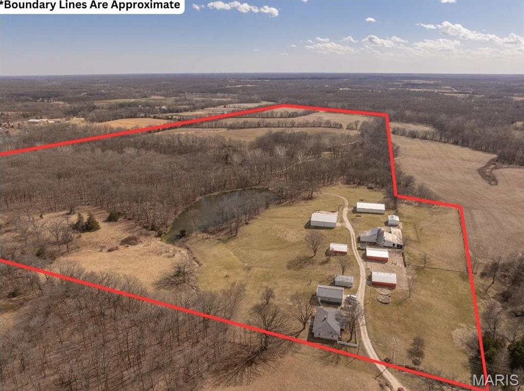 Truly amazing 134+/- acre combination farm located in central Lincoln County. Located less than 1 mile off of hwy 47, this property offers something for everybody. The farm consists of 71 tillable acres, with the rest being pasture and scattered timber. The property fronts Coon Creek and has multiple smaller creeks running through it. An 1800 sq ft 3 bedroom, 2 full bathroom beautiful brick ranch home with hardwood flooring and vaulted ceilings sits overlooking an almost 2 acre pond and is accompanied by several large outbuildings including a 60x50 and 70x45 pole barn. Home had roof replaced in 2024 and septic updated within the past few years. This farm is home to an abundance of wildlife including mature whitetail deer, turkey and quail making it a hunter's paradise. There currently are some fenced areas of pasture that could be used for cows and the remaining pasture could easily be fenced for more cattle or for horses! Pictures do not do this place justice, it is a must see!