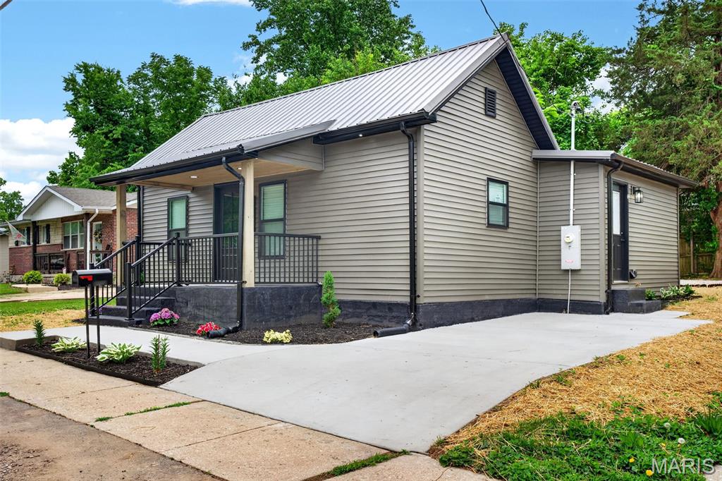 Historic charm meets modern living - completely rebuilt from the studs up in the heart of Bonne Terre
What was once a beloved community fixture, has been given a second life worthy of its 116-year history. This 840 sq ft, 2-bedroom, 2-bathroom home in charming Bonne Terre, MO has been meticulously rebuilt from the studs out, and every detail was chosen with intention. Walk through the front door and you're greeted by soaring coffered ceilings with bold dark beams, warm LVP flooring, and a dramatic 3-sided electric fireplace wrapped in a custom chevron-patterned wood surround making it the unmistakable centerpiece of the living area! The chef-inspired kitchen features all-new stainless appliances (included!), rich dark cabinetry, beautiful countertops, a waterfall sink with integrated glass rinser, gleaming subway tile backsplash, a custom herringbone island, and a dedicated pantry with its own etched glass door. Both bathrooms showcase stunning floor-to-ceiling marble-look tile with black matte fixtures. The spacious primary suite offers a walk-in closet and private bath access. A dedicated laundry room with tankless water heater and side entry door rounds out the thoughtful floor plan. The whole electric setup with multiple mini-split systems delivers flexible, energy-efficient comfort in every season. Outside, enjoy a covered front porch, fresh concrete drive, gravel fire pit patio, and a privacy screen for outdoor relaxation. Literally everything is new: windows, siding, electrical, plumbing. This is truly maintenance-free living. Proudly rehabbed by Frontline Properties, a local veteran-owned company on a mission to revitalize small-town America one home at a time.