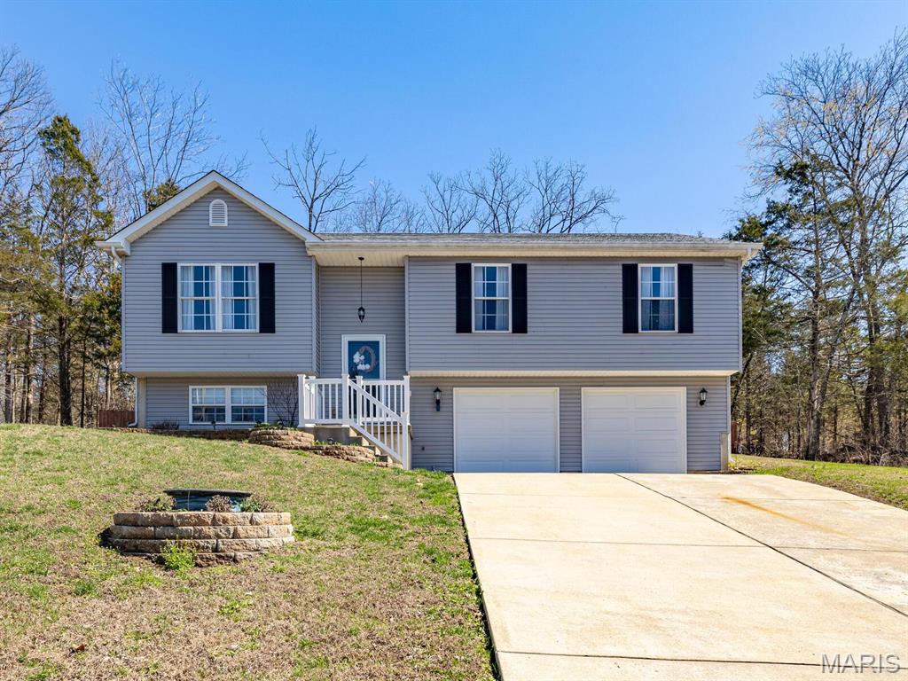 Welcome to your Home Sweet Home and Vacation 24/7 with PRIVACY all around.  This BEAUTIFUL 4 BEDROOMS & 2 FULL BATHS with open floor plan welcomes you with plenty of natural light & a HUGE oversized garage!  Relax & unwind with your fully stocked custom-made bar & a huge new deep freezer that comes with the house!  Your main bedroom has your walk-in closet, as that is a must! All rooms have T.V. mounts as well already installed! The fenced in yard is perfect for entertaining and pets. Lake is so close & walkable to fish your cares away! Your private Home Sweet Home with breathtaking view surrounded by nature is on 1/2 an acre, surrounded by woods & privacy is what most people like in a subdivision, this one has it!  With white sandy beaches, 4 lakes, 18-hole golf course & golf shop, a boat launch, a HUGE saltwater pool with pool side bar & snacks, Country club W/ Restaurant & sports bar & fitness center.  The sought after amazing Hillsboro school district is top notch!  A Raintree Gas Station Market & Grill is in front of subdivision open for your convenience. MAKE THIS HIDDEN GEM, YOUR NEW DREAM - BEFORE IT IS GONE!