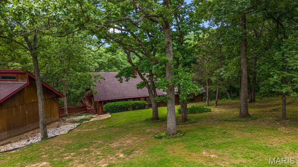 On the market for the first itme in 40 years! this 3 bed/3 bath home is situated on 1.5 wooded acres and offers privacy and seclusion in a small neighborhood setting. With a 2 car detached garage and large deck the exterior is as important as the interior which features a wood burning fireplace, vaulted ceilings and large windows that accentuate the homes relation to the outdoors. Home is being sold "As Is" and is waiting for the perfect Buyer who can see the potential in this one of a kind home.