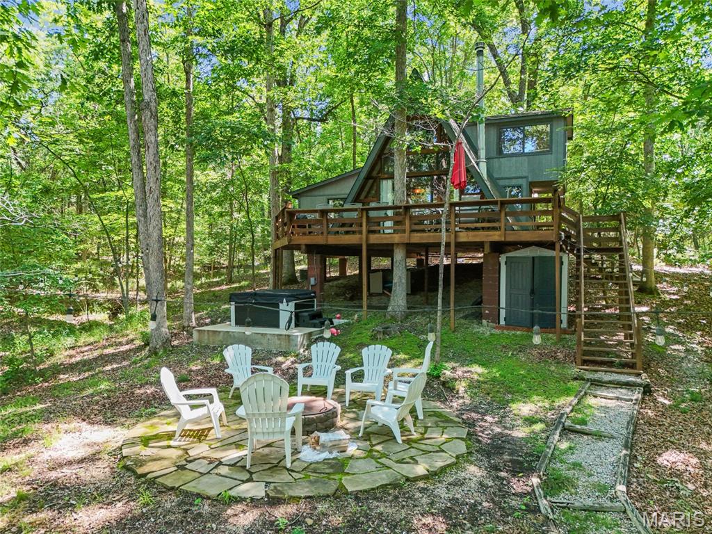 LAKEFRONT CHALET + SHORT-TERM RENTAL OPPORTUNITY IN INNSBROOK!

Escape to your own private waterfront retreat on nearly 3 wooded acres in sought-after Innsbrook. This fully furnished A-frame chalet offers the perfect blend of relaxation, recreation, and investment potential, with the ability to be used as a short-term rental.

Nestled among the trees and overlooking beautiful Shadow Lake, this charming 2-bedroom chalet plus loft comfortably sleeps up to 7 guests and comes turnkey with furnishings included. Inside, you'll find a full kitchen, spacious gathering areas, and new luxury vinyl plank flooring throughout the main level. A wall of windows brings the outdoors in while showcasing peaceful lake views.

Step outside to enjoy the expansive wrap-around deck overlooking a level yard that gently leads to your private dock. Spend your days boating, fishing, or cruising the lake in the included paddle boat with motor. Evenings are made for gathering around the flagstone firepit or unwinding in the new hot tub and platform beneath the stars.

Beyond the property, enjoy all that Innsbrook has to offer, including beaches, lakes, boating, a clubhouse, swimming pool, golf course, fitness center, playgrounds, dog park, hiking trails, and countless year-round activities.

Whether you're searching for a personal getaway, a family retreat, or an income-producing lake property, this waterfront chalet delivers the complete Innsbrook lifestyle. Just bring your suitcase and start making memories!