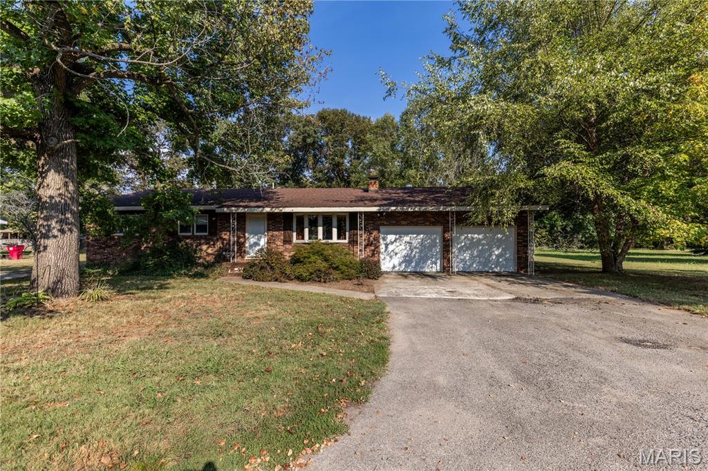 This beautiful home sits right outside city limits in a very desirable neighborhood!  This 2 bedroom 2 bath home has a semi open floor plan and a great flow!  The home was once  a 3 bedroom home and could be made back into one if desired!  When you enter you will notice that there is a beautiful fireplace with built in shelving. Kitchen is open with a place for a dining table or could just use bar stools if no table needed, lots of cabinets, and all appliances stay!  The beautiful sunroom on the back of the house provides an amazing and cozy space to settle in after work and relax or have your morning coffee!  Now when you enter the primary suite the bathroom is huge and has all the features including a large soaking tub.  The primary bedroom is large with a huge walk in closet!!  There is also a custom gun closet in the main hallway! Let not forget that this home has a fully fenced back yard and a large shop as well!!  Schedule your tour today!