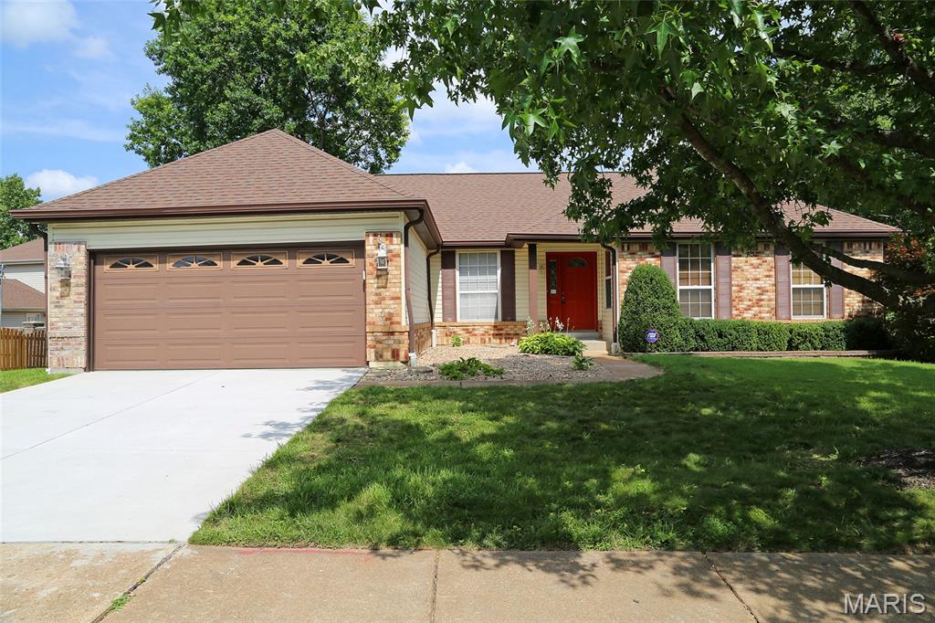 MOVE-IN-READY! 3BR/3BA OPEN CONCEPT RANCH IN SOUGHT-AFTER REMINGTON OAKS! Enter to vaulted ceiling with skylights over the Great Room/Dining Room area. Fireplace in Great Room is flanked by 2 windows that overlook the level fenced backyard that backs to woods. Great Room is open to the large kitchen/breakfast room area. Breakfast bar provides seating for 4. Natural light floods the area from multiple large windows. Laundry/Mud Room just inside the attached garage is adjacent and boasts upper & lower cabinetry that matches the kitchen cabinets. Lovely laminate wood flooring runs throughout the main living areas and down the hall to bedrooms. Primary bedroom with ceiling fan, walk-in closet. & private bath with double sinks, separate shower, & soaking tub with garden window. Two additional bedrooms with ceiling fans. Full hall bath. Walk-out lower level is partially finished with wood laminate flooring. Half bath. Large recreation/family room area with wet bar. Separate office space/sleeping area. Storage room with sliders to backyard & patio. Outside, look for the handy enclosed storage area built into corner of the back of home.  In the Remington Oaks subdivision with clubhouse, 3 pools, small fishing lake with walking trail, tennis court, & pickleball court! House has already passed the St Louis County Occupancy Requirements. Quick closing available.