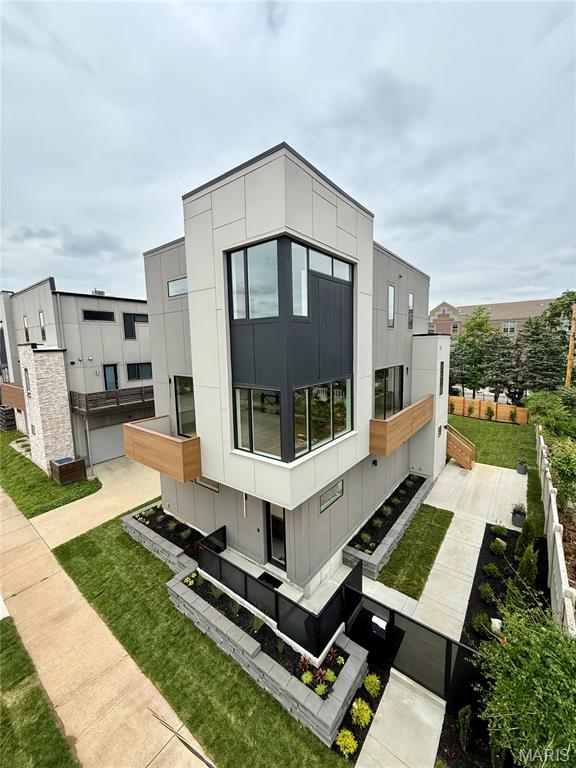 Tax Abated!  Contemporary Loft Living in single family home.  3 bedroom plus office/game room, 4 bathrooms, finished garage with epoxy floor.  Striking example of modern architecture, upscale premium finishes throughout.  Coffee shop/restaurant (have a cow) steps away.  Finishes include 10' ceilings, massive windows, stunning kitchen ,sprawling quartz countertops, oversized porcelain tile, Wood; Polished Concrete and Carpet floors, zoned climate control (2 separate systems), EV charger and solar ready, attached 2 car garage. Entertain friends in open floor plan, or outside with multiple outdoor entertaining areas.  Custom staircase - one of a kind. Walk-in closets with built-ins. Phone controllable lighting, thermostats, and cameras.  Walking distance to restaurants and cafes; Lafayette Square, SLU Medical Campus and new SLU hospital, and Cardinal Glennon Hospital. Centrally located - 5 min. drive to Downtown, Central West End, BJC/Wash U Medical campus, The Grove, Soulard, South Grand, Tower Grove Park.  Easy access to all highways 40, 44, 55, 70.