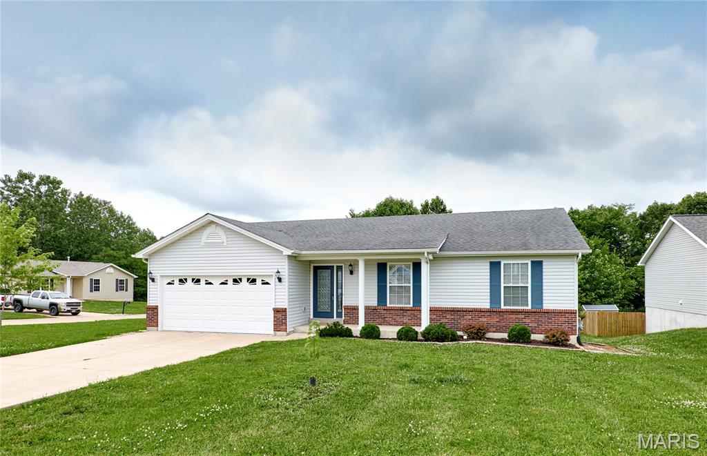 Original owner and lovingly maintained, this move-in ready ranch is perfectly located for an easy Moscow Mills and Hwy 61 commute! Situated on a spacious corner lot backing to mature trees, this 3BR/2.5BA home offers privacy, plenty of parking with a 2-car garage plus driveway space for 4+ vehicles, and a welcoming open floor plan with vaulted ceilings. The main level features a cozy wood-burning fireplace, main floor laundry, a true foyer with coat closet, and a spacious kitchen/dining area with access to the deck overlooking the wooded backyard. The primary suite includes a large walk-in closet, while the finished walkout lower level expands your living space with a large rec room, built-in bar, storage/workshop areas, half bath, and patio access. Recent updates include a newer HVAC system and water heater. Natural gas is available, and a gas log set for the fireplace will stay with the home. This well-cared-for property is ready for its next owner—schedule your showing today! Showings start 6/27/2026.