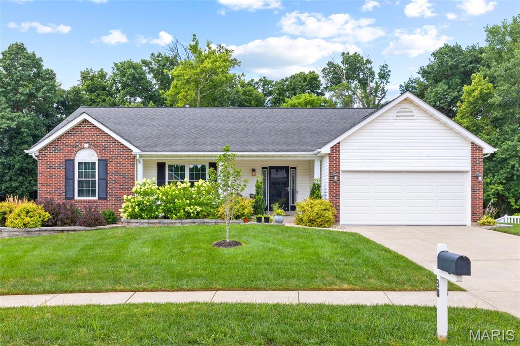 Who's looking for an updated brick-front home on a quiet cul-de-sac backing to woods and common ground?! This spacious home features an open floor plan w/ a walk-out basement, vaulted great room, primary suite & upgrades galore. The great room is highlighted by a wood-burning marble fireplace, new main-level windows w/ an abundance of natural light & engineered hardwoods throughout the main living area. You'll find new carpet in all 3 main bedrooms & luxury vinyl flooring in the bathrooms & main-floor laundry room. The kitchen offers custom white cabinetry with updated hardware, a center island/breakfast bar, pantry, stainless steel appliances & a bright breakfast area. The vaulted primary suite, including a walk-in closet, double vanity, garden tub & separate shower, is every homeowner's dream. The finished walk-out lower level adds extra square footage w/ an entertainment room, 4th bedroom, full bath, plenty of storage & French doors leading to the backyard. Enjoy the private, tree-lined yard from the Veka composite deck (2019) or shaded patio. Additional updates include a newer furnace and A/C (2022), 50-gallon water heater (2024), plus fresh landscaping including Green Vase Zelkova & Judy Zuk Magnolia trees. Ask your agent for a list of other improvements! Don't forget the 2 car garage with a 3-foot bump-out, epoxied floor & fully drywalled. You can't beat the location...minutes from 94, shopping, dining, entertainment, Francis Howell School District, you name it!