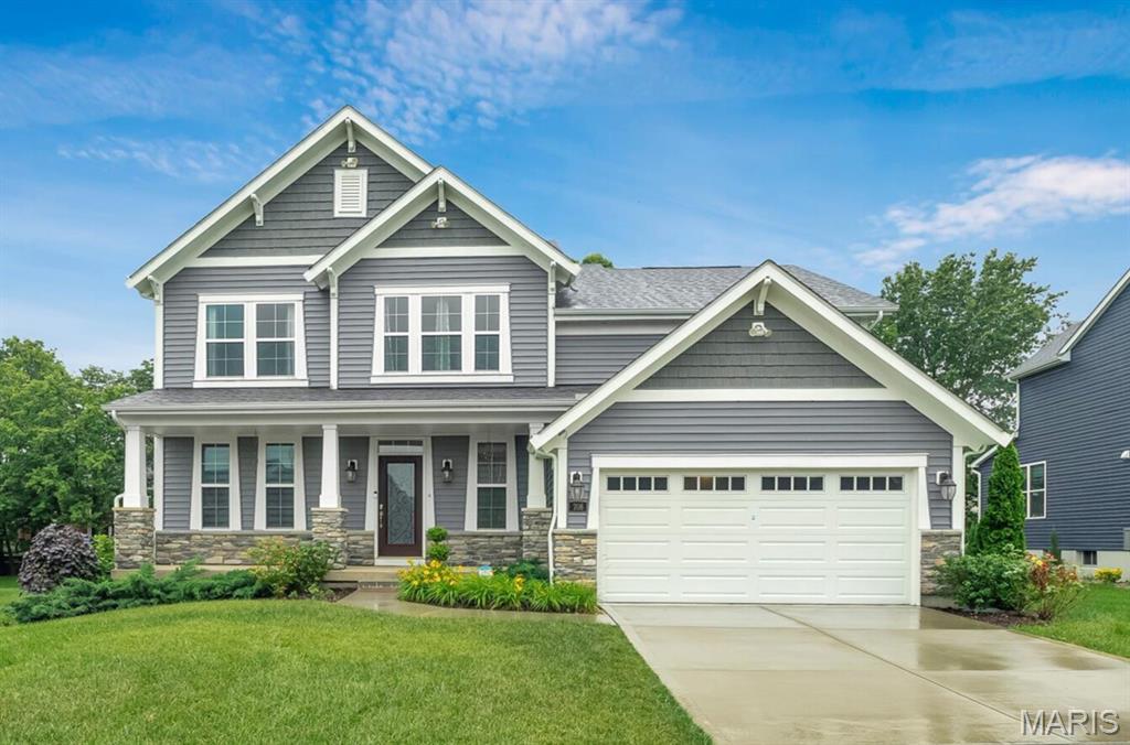 Welcome to this stunning 3-year-old, 5-bed, 3.5-bath home tucked near the back of a quiet cul-de-sac in the highly sought-after Inverness community of Dardenne Prairie. From the inviting front porch and charming stone accents to the open, light-filled layout with soaring two-story ceilings, this home makes an impression from the moment you walk in. The chef’s kitchen is built to impress, featuring white cabinetry, granite countertops, subway tile backsplash, and stainless steel appliances—including a smart Samsung refrigerator. Upstairs, you’ll find a luxurious primary suite with dual walk-in closets and a spa-like bath, along with a versatile fifth bedroom perfect for a home office, gym, or playroom. Step outside and enjoy the private wooded backdrop, plus a 9’ pour lower level ready for your finishing touches. This is the one you’ve been waiting for—schedule your showing today before it’s gone.