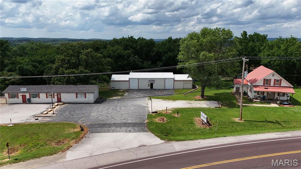 Exceptional investment opportunity zoned CC2, with multiple income-producing possibilities in a highly visible, high-traffic location! Situated on approximately 1.38 acres, this versatile property features a 3,600 sq. ft. shop, 9 storage units, a retail building, a 2 bedroom 1 bath apartment, and a 3 bedroom 1 bath home.

Whether you're looking to operate your own business on-site, expand your investment portfolio, or create a mixed-use income property, the opportunities here are endless. Both residential units are currently tenant-occupied, providing immediate income potential, while the shop, storage units, and retail space offer additional revenue streams or owner-use flexibility.

The 3,600 sq. ft. shop is currently utilized as a welding business but offers incredible versatility for a variety of commercial uses. With ample workspace and excellent accessibility, it could be ideal for an automotive repair facility, fabrication shop, contractor headquarters, equipment service business, landscaping company, warehouse operations, or even a veterinary clinic, subject to buyer verification and applicable zoning requirements.

The retail building also includes a basement level that could be utilized for office space, storage, workshop space, or renovated for additional rental income. With room to expand and add more storage units or additional business opportunities, this property offers significant upside for the visionary investor.

Conveniently located with quick access to major highways throughout Jefferson County, this property benefits from excellent visibility, strong traffic counts, and easy accessibility. Whether you're seeking a property to house your business, generate rental income, or both, this unique commercial opportunity offers the flexibility and potential to make your vision a reality.