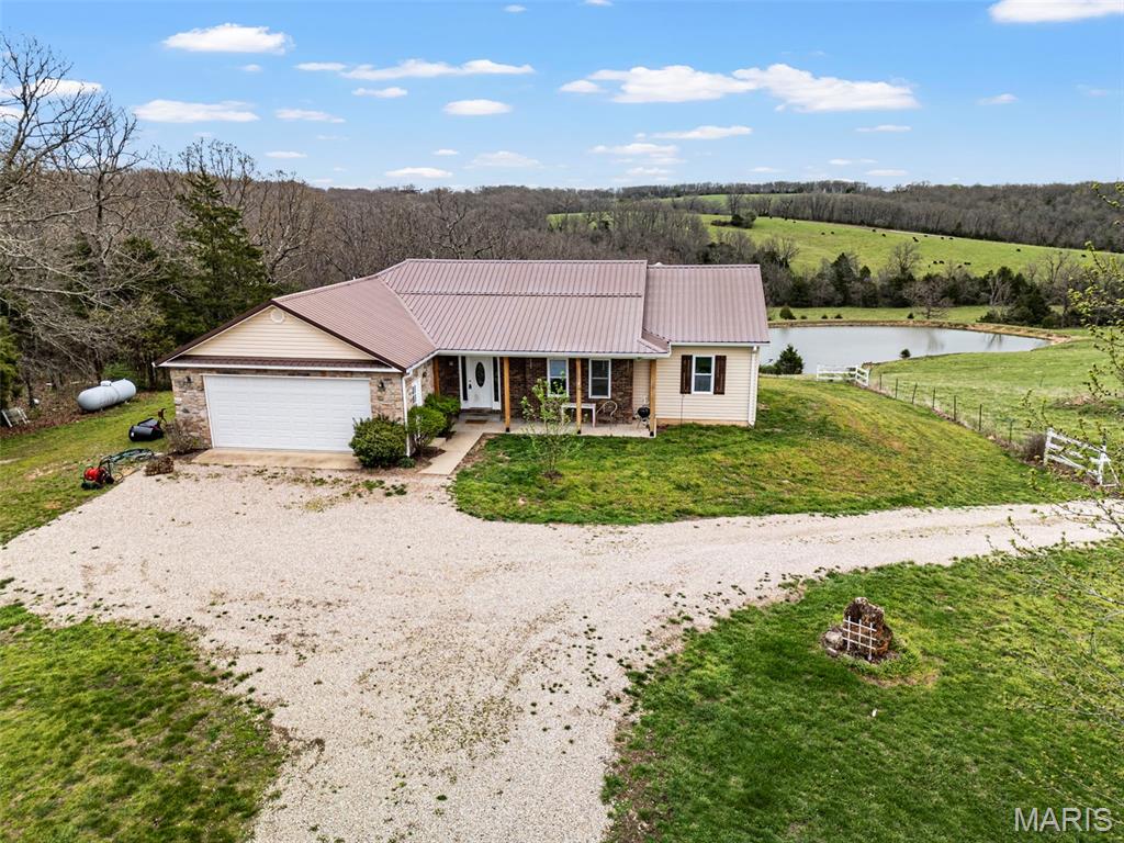 This property truly has it all—acreage, water features, and versatile living spaces all in one incredible setting. Situated on 60.8 picturesque acres, this property offers a rare opportunity for farming, recreation, or multi-generational living.

The main home features a 3 bed, 2 bath ranch layout with an attached 2-car garage, offering comfortable, single-level living. In addition, a detached 3-car garage includes a fully equipped apartment above complete with 1 bedroom, 1 bath, full kitchen, and private laundry, making it ideal for guests, rental income, or extended family.

The land is perfectly suited for agricultural use with ample pasture for livestock, along with a stocked 2/3-acre pond and an additional pond for cattle. Whether you're looking to raise animals, start a hobby farm, or simply enjoy wide-open space and privacy, this property delivers endless possibilities.

A rare combination of functionality, income potential, and natural beauty—don’t miss your chance to own this exceptional piece of Missouri countryside.