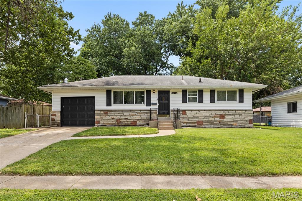 Welcome home to this beautifully maintained 3-bedroom, 1-bath ranch with a 1-car attached garage, nestled on a quiet street in the Lockbriar subdivision of Florissant. Offering outstanding curb appeal and true move-in-ready condition, this home is the perfect opportunity for first-time homebuyers, those looking to downsize, or savvy investors seeking turn-key opportunities. From the moment you step inside, you'll appreciate the luxury vinyl flooring throughout, large picturesque windows that flood the home with natural light, and three generously sized bedrooms with ample closet space. The inviting eat-in kitchen provides plenty of room for everyday dining, while the beautifully updated bathroom features a stylish ceramic tile tub surround. A bright and versatile sunroom offers the perfect space to unwind, create a home office, or design the ultimate playroom. The unfinished lower level provides a spacious laundry and utility area, abundant storage, and endless possibilities to finish and customize to fit your lifestyle. Step outside to enjoy the expansive fenced-in backyard and large deck just off the kitchen—perfect for summer barbecues, family gatherings, gardening, or simply relaxing with your morning cup of Joe. Conveniently located near parks, schools, shopping, restaurants, and major highways, this home offers the ideal combination of comfort, convenience, and value.